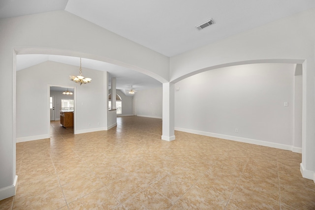 unfurnished living room with lofted ceiling and ceiling fan with notable chandelier