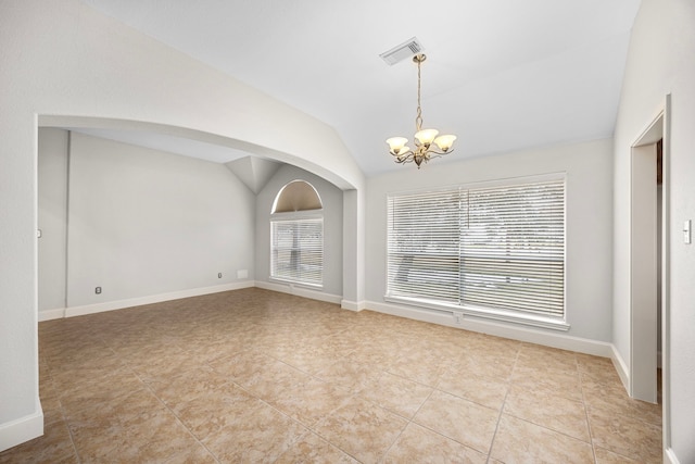 tiled empty room with an inviting chandelier, lofted ceiling, and plenty of natural light