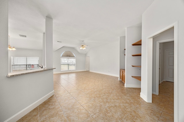 unfurnished living room featuring lofted ceiling, light tile patterned floors, and ceiling fan