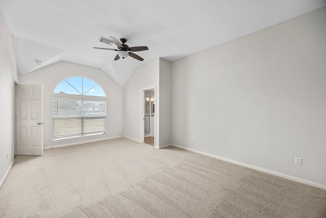 spare room with ceiling fan, light colored carpet, and lofted ceiling