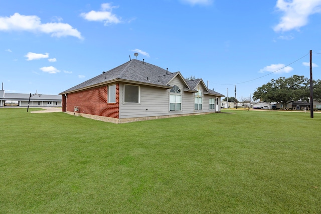 back of house with a lawn