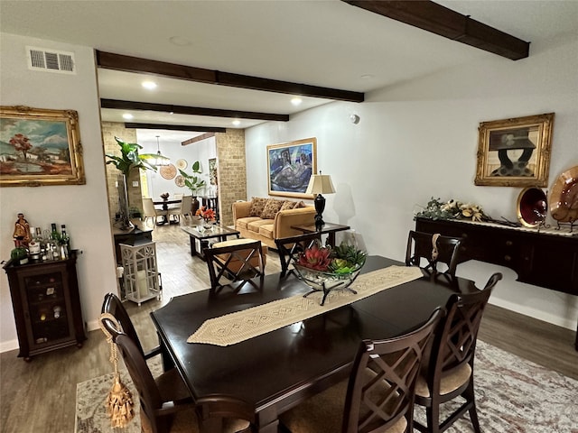 dining area with hardwood / wood-style flooring and beam ceiling