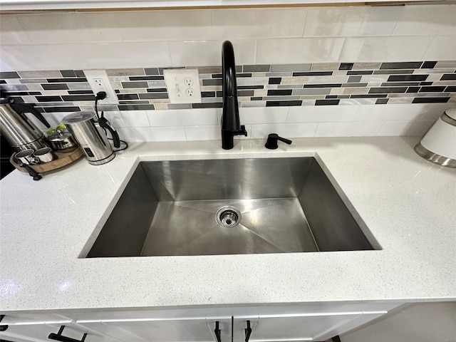 details featuring sink and decorative backsplash