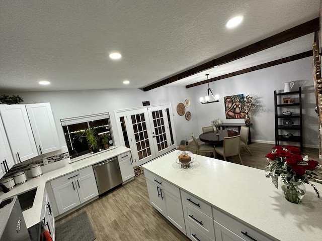 kitchen featuring pendant lighting, white cabinets, french doors, and dishwasher