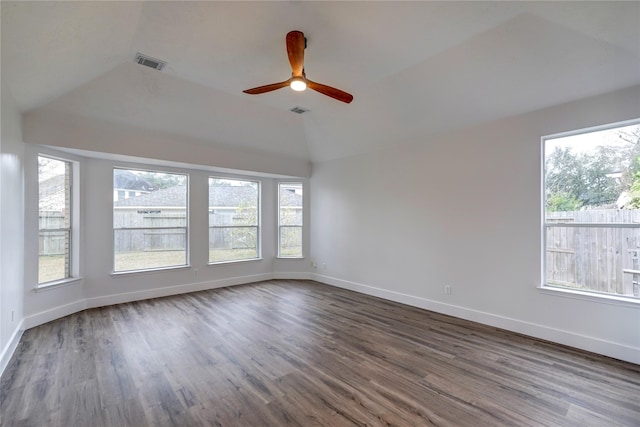 empty room with lofted ceiling, hardwood / wood-style flooring, and ceiling fan