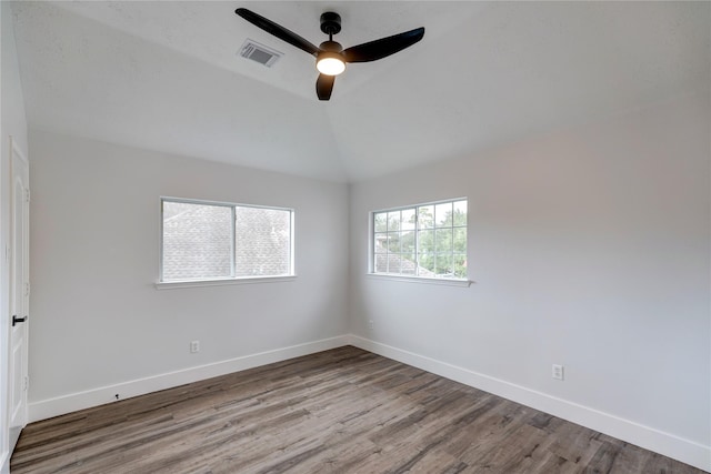 spare room featuring vaulted ceiling, ceiling fan, and light wood-type flooring