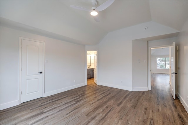 spare room with ceiling fan, wood-type flooring, and vaulted ceiling