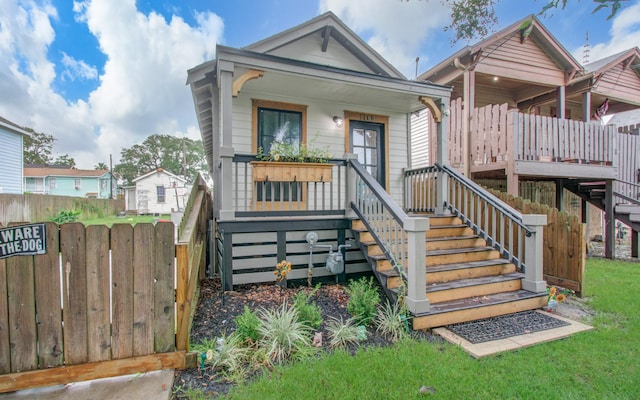 rear view of house featuring covered porch