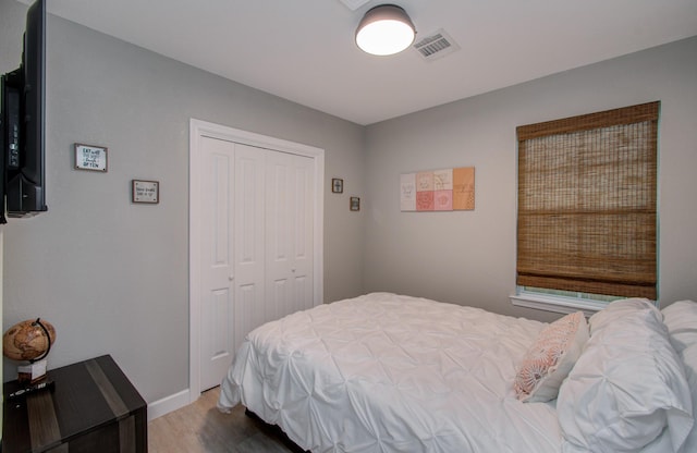 bedroom with hardwood / wood-style flooring and a closet