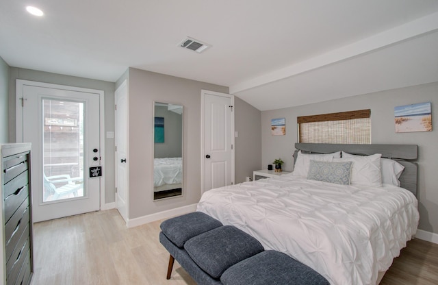 bedroom featuring vaulted ceiling and light wood-type flooring