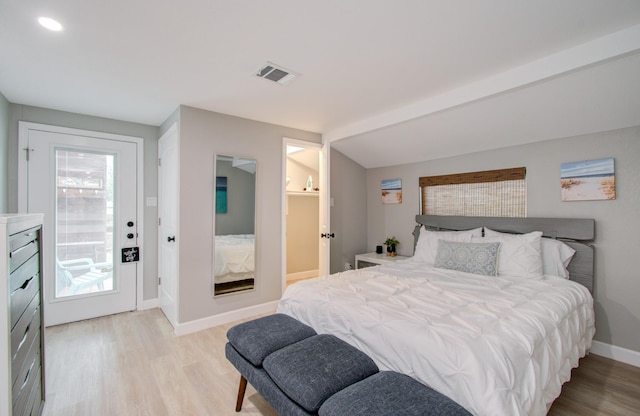 bedroom featuring vaulted ceiling and light hardwood / wood-style floors