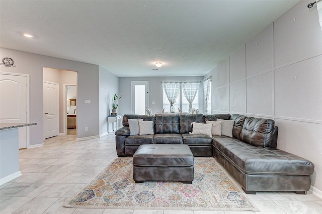 tiled living room with a textured ceiling