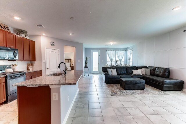 living room featuring sink and light tile patterned floors