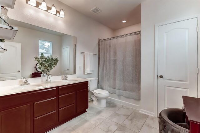 bathroom with vanity, toilet, and walk in shower