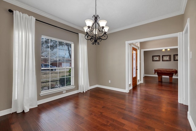 unfurnished room with crown molding, billiards, dark hardwood / wood-style floors, and an inviting chandelier