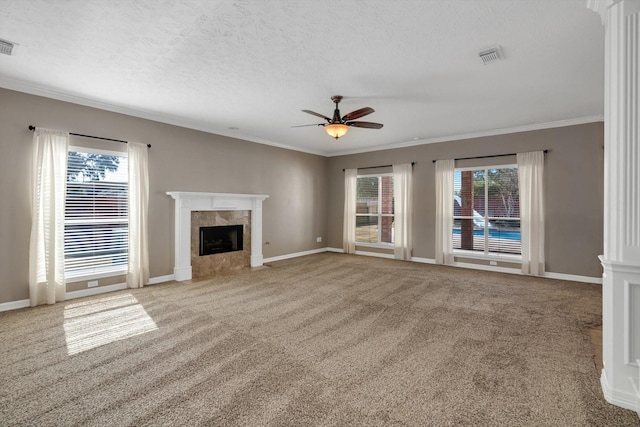 unfurnished living room featuring light carpet, crown molding, a high end fireplace, and ceiling fan