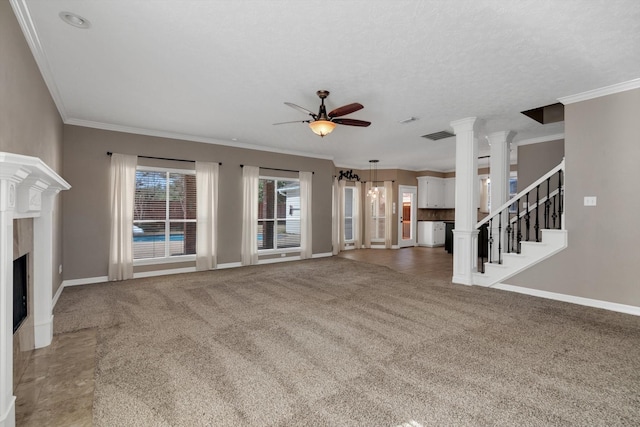 unfurnished living room with decorative columns, crown molding, carpet floors, and ceiling fan