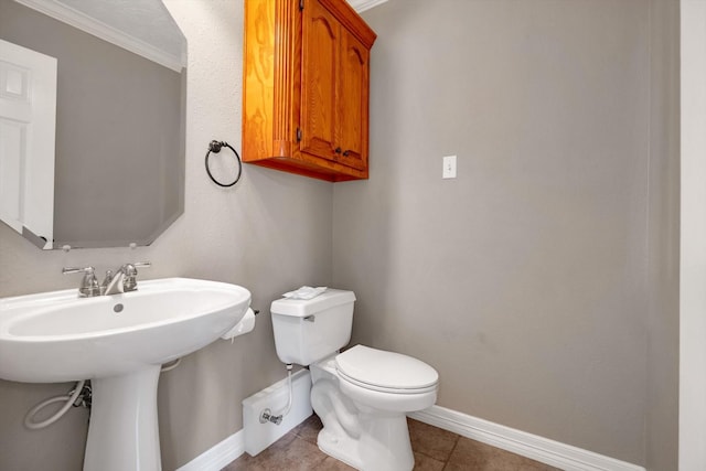 bathroom featuring sink, toilet, and tile patterned flooring