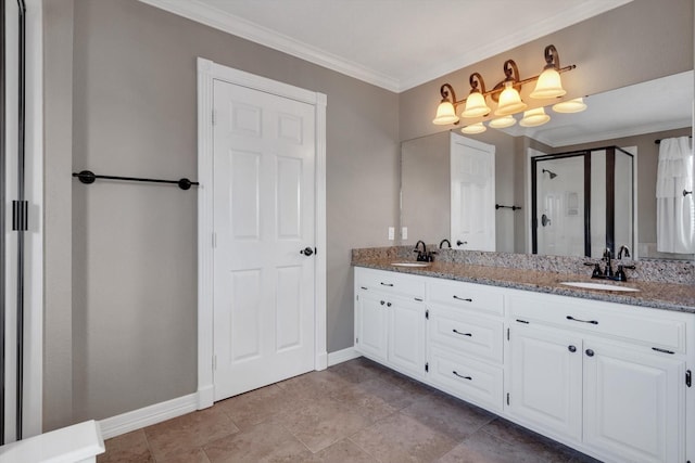 bathroom with vanity, a shower with shower door, and ornamental molding