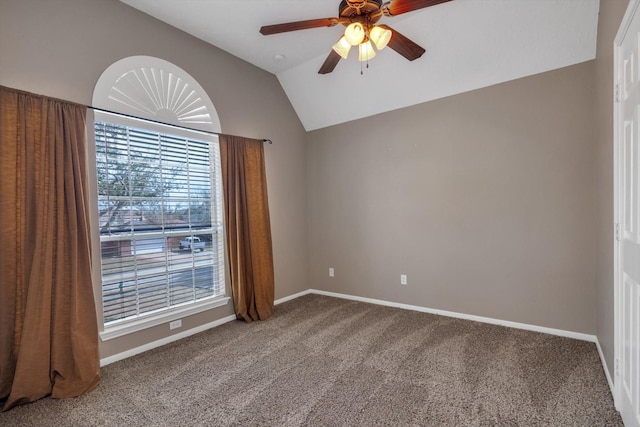 spare room with vaulted ceiling, ceiling fan, and carpet flooring