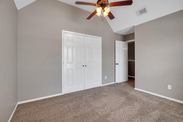 unfurnished bedroom with ceiling fan, lofted ceiling, carpet flooring, and a closet