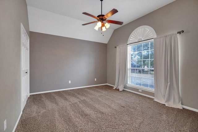 empty room featuring ceiling fan, lofted ceiling, and carpet floors