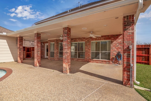 rear view of property featuring a patio and ceiling fan