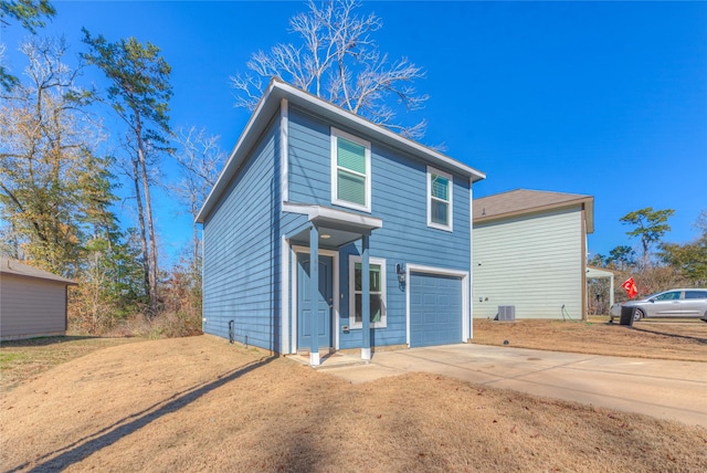 view of front of property featuring concrete driveway and an attached garage