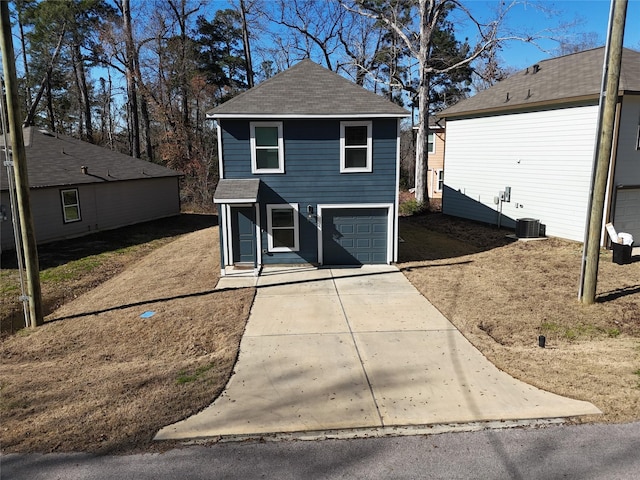 view of front of property featuring driveway, a shingled roof, and a garage