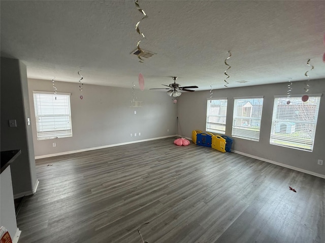 interior space featuring dark wood-type flooring and a healthy amount of sunlight