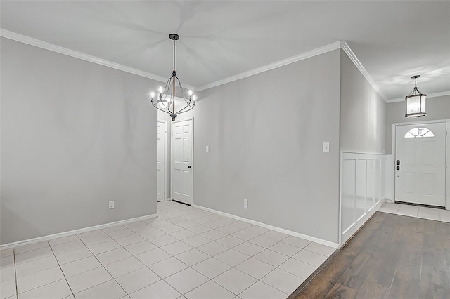 interior space featuring crown molding, an inviting chandelier, and light hardwood / wood-style floors