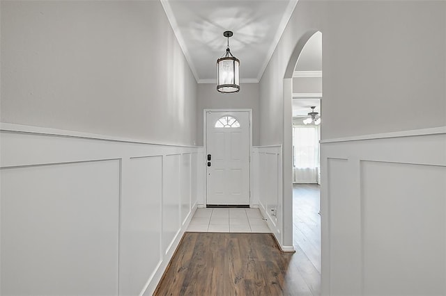 doorway to outside featuring crown molding and hardwood / wood-style floors