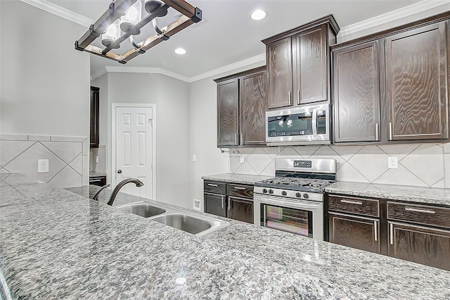 kitchen with sink, crown molding, dark brown cabinets, and stainless steel appliances