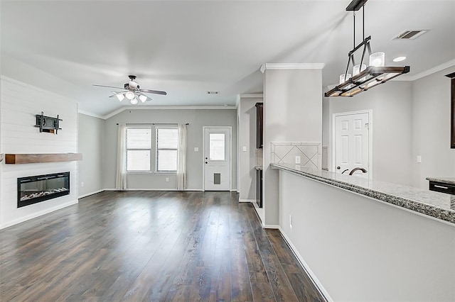 unfurnished living room featuring crown molding, ceiling fan, lofted ceiling, and dark hardwood / wood-style flooring