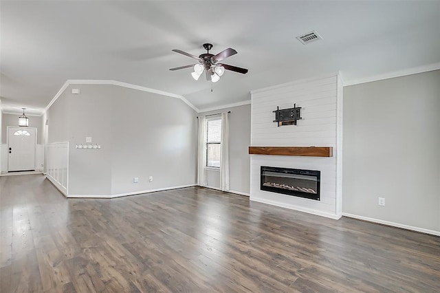 unfurnished living room featuring vaulted ceiling, a fireplace, ceiling fan, crown molding, and dark wood-type flooring