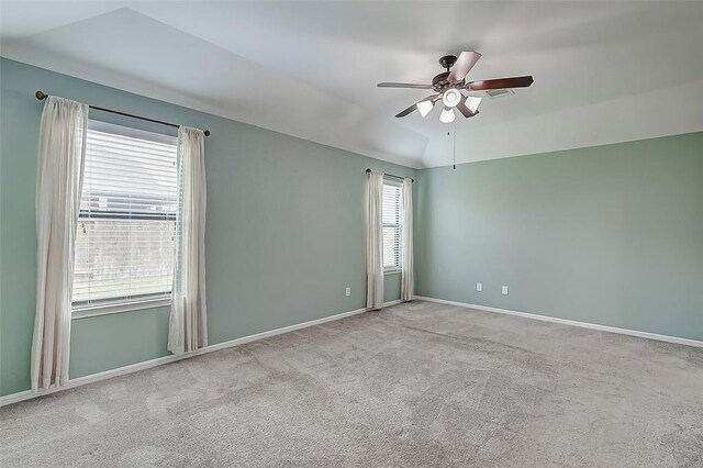 unfurnished room featuring vaulted ceiling, light colored carpet, and ceiling fan