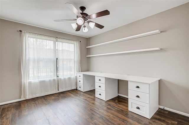 unfurnished office featuring dark wood-type flooring and ceiling fan