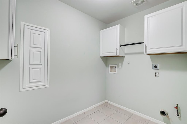 washroom with light tile patterned flooring, cabinets, hookup for a washing machine, hookup for an electric dryer, and hookup for a gas dryer