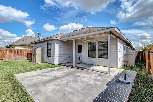 rear view of property featuring a patio, ceiling fan, and a lawn