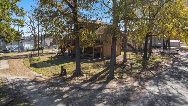 1382 Indian Hill Blvd, Livingston, TX 77351 - exterior space with fence, a deck, and stairs