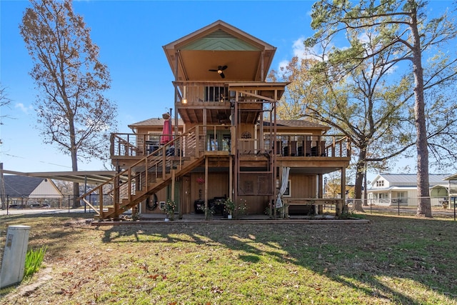 1382 Indian Hill Blvd, Livingston, TX 77351 - rear view of house featuring a wooden deck, a yard, stairway, and fence