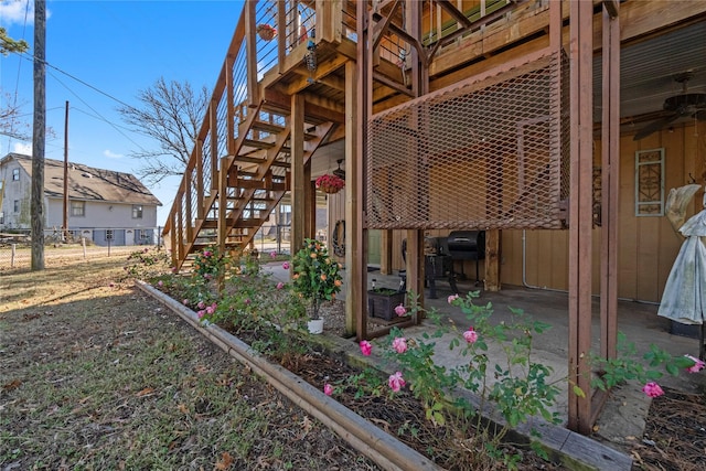 1382 Indian Hill Blvd, Livingston, TX 77351 - exterior space featuring stairway, ceiling fan, fence, and a deck