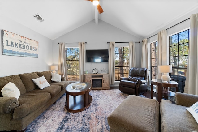 living room featuring ceiling fan, hardwood / wood-style floors, and vaulted ceiling with beams