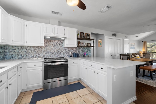 1382 Indian Hill Blvd, Livingston, TX 77351 - kitchen with a peninsula, stainless steel electric range, a ceiling fan, and visible vents