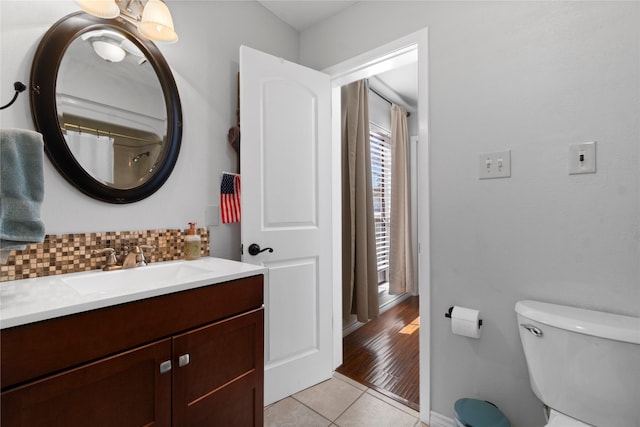1382 Indian Hill Blvd, Livingston, TX 77351 - full bathroom with toilet, vanity, tile patterned flooring, and tasteful backsplash