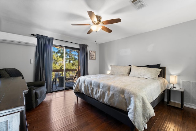 bedroom with access to outside, a wall unit AC, dark hardwood / wood-style floors, and ceiling fan