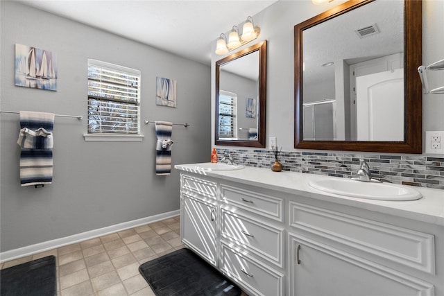 1382 Indian Hill Blvd, Livingston, TX 77351 - full bathroom with baseboards, tasteful backsplash, a sink, and visible vents
