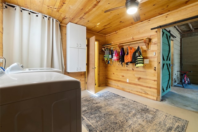 1382 Indian Hill Blvd, Livingston, TX 77351 - clothes washing area featuring washing machine and clothes dryer, wooden walls, wooden ceiling, and a ceiling fan