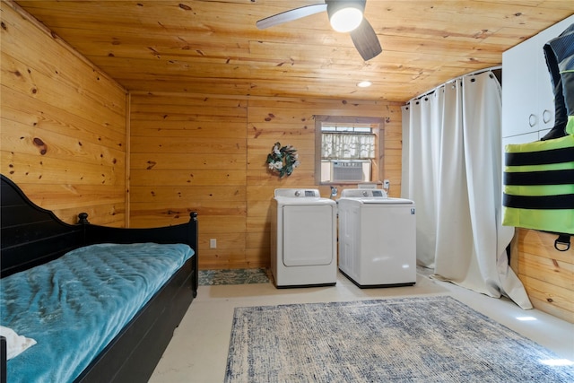 bedroom featuring wood walls, cooling unit, ceiling fan, wooden ceiling, and washer and clothes dryer