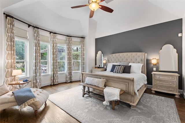 bedroom with lofted ceiling, hardwood / wood-style floors, and ceiling fan